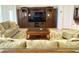 Cozy living room features a large entertainment center and comfortable furnishings at 3341 Pawleys N Loop, St Cloud, FL 34769