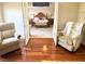View from the sitting room into the main bedroom featuring a king bed and matching nightstands at 3341 Pawleys N Loop, St Cloud, FL 34769