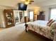 Cozy main bedroom featuring a ceiling fan, television, and adjacent sitting room at 3341 Pawleys N Loop, St Cloud, FL 34769