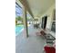 Relaxing covered patio with comfortable seating, a ceiling fan, and pool views at 3341 Pawleys N Loop, St Cloud, FL 34769