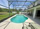 Serene pool area features a spa, screened enclosure, and a relaxing outdoor space with seating at 3341 Pawleys N Loop, St Cloud, FL 34769