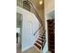 Staircase with dark, wrought iron railing and wood steps ascends to the second floor at 3341 Pawleys N Loop, St Cloud, FL 34769