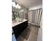 Bright bathroom featuring a double sink vanity and a shower-tub combo at 3920 Southern Vista Loop, St Cloud, FL 34772