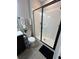 A modern bathroom featuring a glass shower, gray tile and a white toilet at 3920 Southern Vista Loop, St Cloud, FL 34772