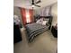 This bedroom features a ceiling fan, art on the wall and a bedside table at 3920 Southern Vista Loop, St Cloud, FL 34772