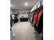Large walk-in closet providing ample storage with racks, shelves and drawers at 3920 Southern Vista Loop, St Cloud, FL 34772