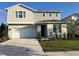 Charming two-story home featuring a two-car garage and beautifully landscaped front yard on a sunny day at 3920 Southern Vista Loop, St Cloud, FL 34772