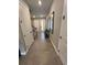Inviting hallway with tile flooring, stylish decor, and natural light streaming through the front door at 3920 Southern Vista Loop, St Cloud, FL 34772
