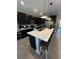Modern kitchen featuring dark cabinets, a center island with seating, and pendant lighting at 3920 Southern Vista Loop, St Cloud, FL 34772