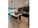 Spacious kitchen with an island, bar stool seating, stainless steel appliances, and ample cabinet space at 3920 Southern Vista Loop, St Cloud, FL 34772