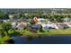 Aerial view of property showing pool, proximity to lake, and surrounding neighborhood at 3928 Blackberry Cir, St Cloud, FL 34769