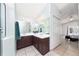 Bright bathroom featuring dual sinks with a shared mirror, tiled floor and walk-in shower at 3928 Blackberry Cir, St Cloud, FL 34769
