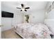 Cozy bedroom featuring tile flooring, ceiling fan, a window, and a closet at 3928 Blackberry Cir, St Cloud, FL 34769