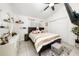 Bedroom with a queen bed, neutral bedding, vanity, and TV; ceiling fan at 3928 Blackberry Cir, St Cloud, FL 34769