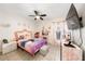 Bright bedroom with a pink theme, tile floors, a ceiling fan and a window at 3928 Blackberry Cir, St Cloud, FL 34769