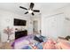 bedroom with tile flooring, ceiling fan, large closet, and bright window at 3928 Blackberry Cir, St Cloud, FL 34769