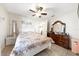 Comfortable bedroom with ceiling fan, tile flooring and a bright window at 3928 Blackberry Cir, St Cloud, FL 34769