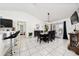 Bright dining room with tile floors, modern lighting, and adjacent breakfast bar seating at 3928 Blackberry Cir, St Cloud, FL 34769