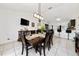 Open concept view of dining room with modern light fixture and adjacent breakfast bar seating at 3928 Blackberry Cir, St Cloud, FL 34769