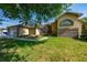 Charming home featuring a manicured lawn, palm trees, and a welcoming entrance at 3928 Blackberry Cir, St Cloud, FL 34769