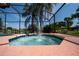 Hot tub with a water feature and palm trees within a screened enclosure, overlooking the lake at 3928 Blackberry Cir, St Cloud, FL 34769
