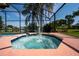 Inviting screened hot tub with a water feature and palm trees, a perfect relaxation spot at 3928 Blackberry Cir, St Cloud, FL 34769