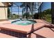 A bubbling screened-in hot tub with a water feature overlooking a serene lake at 3928 Blackberry Cir, St Cloud, FL 34769