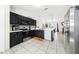 Kitchen with black cabinets, stainless steel appliances, white countertops and dining room view at 3928 Blackberry Cir, St Cloud, FL 34769