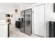 Stainless steel refrigerator and adjacent kitchenette storage in this well-lit kitchen at 3928 Blackberry Cir, St Cloud, FL 34769