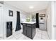 Bright kitchen island with black cabinets and tile floor, perfect for casual dining at 3928 Blackberry Cir, St Cloud, FL 34769