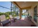 Screened lanai showing pool, lake and outdoor seating at 3928 Blackberry Cir, St Cloud, FL 34769