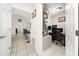 Office area with a desk, chair, and computer setup; hallway with barstool seating in view at 3928 Blackberry Cir, St Cloud, FL 34769