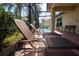 Relaxing patio with screened enclosure featuring comfortable lounge chairs and scenic pool view at 3928 Blackberry Cir, St Cloud, FL 34769