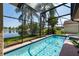 Inviting pool and spa surrounded by a screened enclosure and a tranquil lake view at 3928 Blackberry Cir, St Cloud, FL 34769