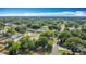 Sprawling aerial view capturing a lush residential area with mature trees, cozy homes, and a blue sky backdrop at 401 Maryland Ave, St Cloud, FL 34769