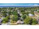 Picturesque aerial shot of a residential neighborhood, highlighting cozy homes, mature trees, and the sparkling bay in the distance at 401 Maryland Ave, St Cloud, FL 34769
