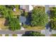 Aerial view of a well-maintained property featuring a dark roof, lush trees, and a serene neighborhood setting at 401 Maryland Ave, St Cloud, FL 34769
