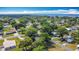 Beautiful aerial view of a vibrant neighborhood featuring mature trees, well-kept homes, and a glimpse of the serene bay at 401 Maryland Ave, St Cloud, FL 34769
