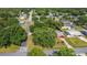 Neighborhood aerial view of a charming single-story home with a red roof and ample greenery surrounding it at 401 Maryland Ave, St Cloud, FL 34769