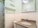 Cozy bathroom featuring a charming vanity, toilet, and tub with playful accents at 401 Maryland Ave, St Cloud, FL 34769