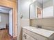 Bathroom featuring white vanity, tiled walls, and view into another room at 401 Maryland Ave, St Cloud, FL 34769