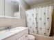 Bathroom featuring a white vanity, toilet, and shower/tub combination with palm tree shower curtain at 401 Maryland Ave, St Cloud, FL 34769
