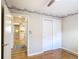 Bedroom with hardwood floors, a ceiling fan, and a view into the kitchen at 401 Maryland Ave, St Cloud, FL 34769