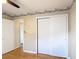 Bedroom featuring hardwood floors, closet with sliding doors and views into the hall at 401 Maryland Ave, St Cloud, FL 34769