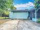 Home exterior featuring a garage, driveway, and screen porch at 401 Maryland Ave, St Cloud, FL 34769