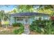 Charming single-story home featuring lush landscaping and a welcoming front entrance at 401 Maryland Ave, St Cloud, FL 34769