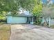Home exterior showing the driveway, garage, and enclosed porch at 401 Maryland Ave, St Cloud, FL 34769