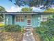 Classic light blue home showcasing a well-manicured lawn, front door, and shuttered windows at 401 Maryland Ave, St Cloud, FL 34769