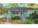 Charming single-story home features a light blue exterior, well-maintained landscaping, and a welcoming front entrance at 401 Maryland Ave, St Cloud, FL 34769
