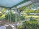 Cozy front porch view with decorative metal supports, lush landscaping, and neighborhood street view at 401 Maryland Ave, St Cloud, FL 34769